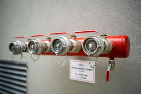 Red bayonets for connecting fire hoses in an industrial buildingの写真素材