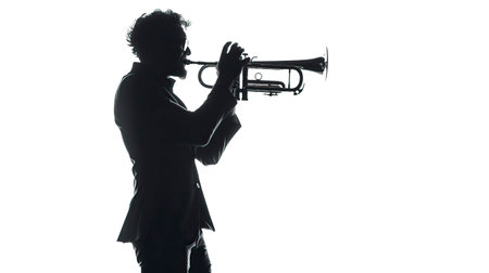 Silhouette of a young man playing the trumpet on white backgroundのイラスト素材