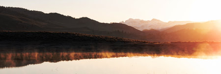 Steam from ephemeral ponds lit up at sunriseの写真素材