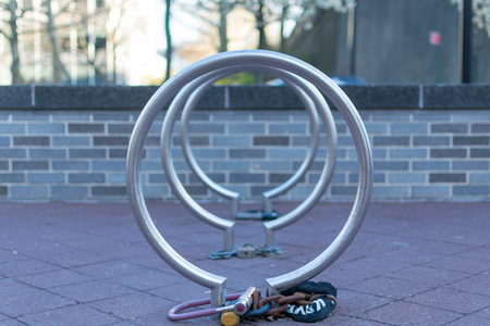 Old bike locks on some empty bicycle stands in New York City