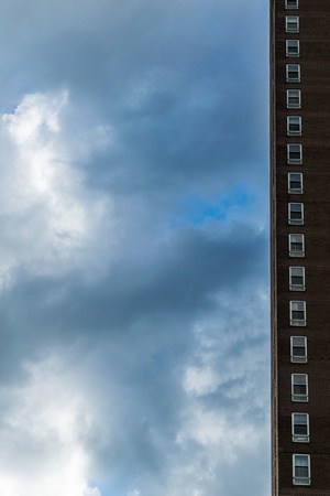 One row of windows along a sliver of a New York City highrise building against a beautiful blue sky...