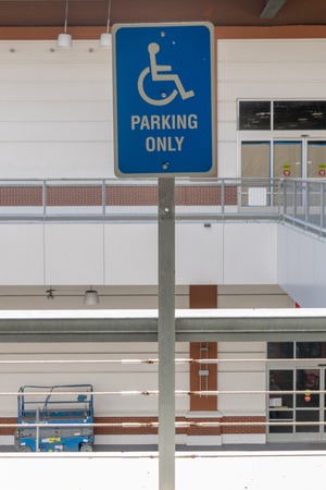 Blue and white reserved parking sign mounted on a metal poleの写真素材