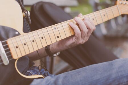 Older male musician playing guitar on a New York City Streetの写真素材
