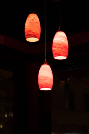 Ceiling lights illuminate a dark bar, in New York Cityの写真素材