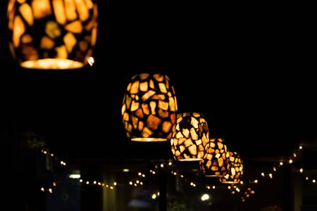 Ceiling lights illuminate a dark bar, in New York Cityの写真素材