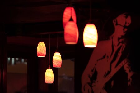 Ceiling lights illuminate a dark bar, in New York Cityの写真素材