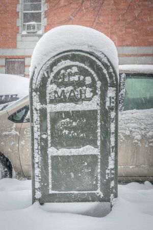 Post office mail box covered in snow, on a cold snowy winter day in New York Cityのeditorial素材