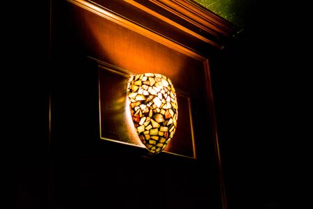 Ceiling light illuminates a dark bar, in New York Cityの写真素材
