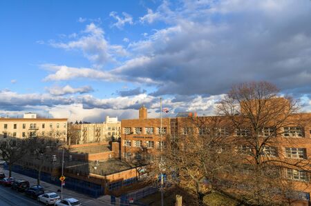 Bronx, NY/USA - 01/16/2020: New York City public school building beneath a cloud-filled skyのeditorial素材