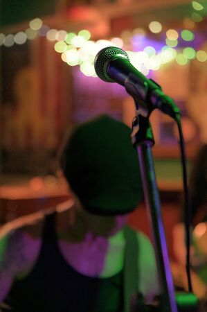 Focused on a microphone at a concert in a small venue in New York City, NYC, NY