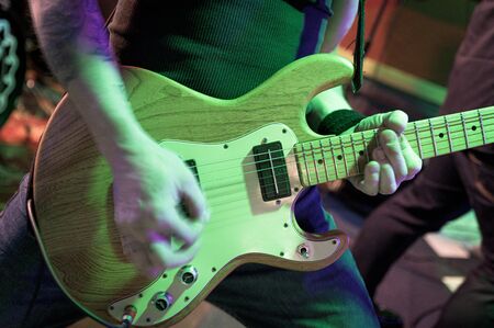Rock musician at a concert in a small venue playing the guitar, New York City, NYC, NYの写真素材