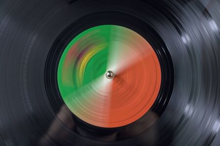 Close-up of a vinyl record spinning on a turntableの写真素材