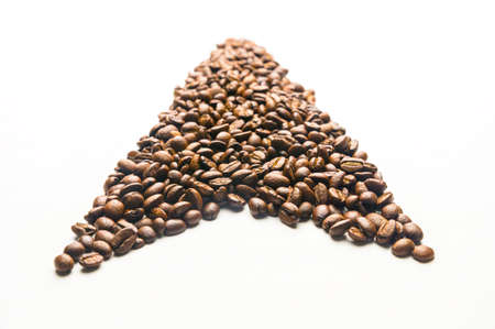 Roasted coffee beans forming an arrow, pointing upward, isolated on a white backgroundの写真素材