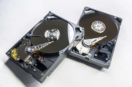 Old-fashioned, open, mechanical harddisc drives, isolated on a white background