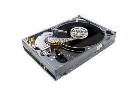Old-fashioned, open, mechanical harddisc drive, isolated on a white backgroundの写真素材