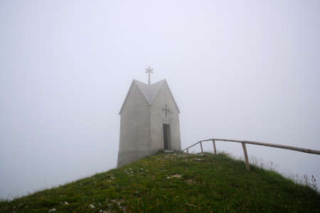 Little mountain church in the fogの写真素材