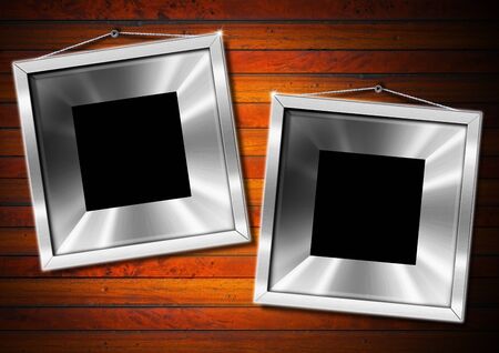 Two empty metallic frames on a old dark wooden wallの写真素材