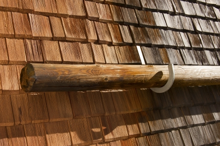 Detail of old wooden roof with snow guard trunk - Trento Italyの写真素材