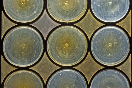 Old window with stained glass - opaque blue and yellow circles
の写真素材