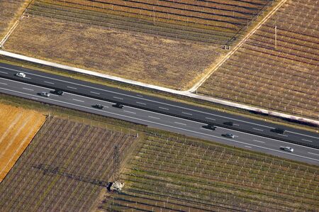 Aerial view of the Adige Valley with highway and cultivated fieldsの写真素材