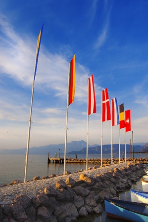 Cisano harbor with boats and flags to Garda Lake  - Verona - Italyの写真素材