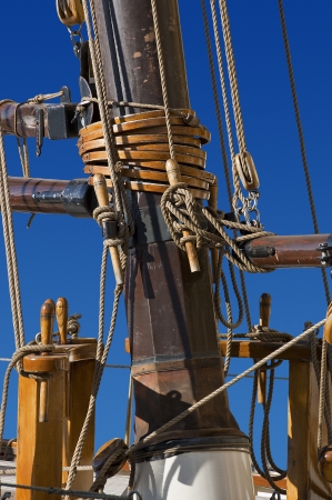 Detail of old mast of sailing ship with ropes on blue skyの写真素材