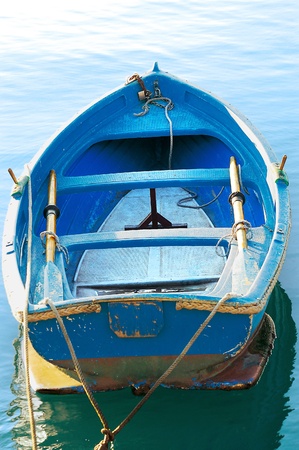 Blue rowing boat moored in a harbor - Lerici - Italyの写真素材