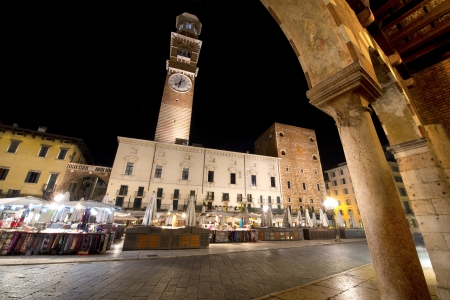 Piazza delle Erbe by night and medieval tower of the Lamberti in Verone - Italyのeditorial素材