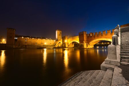 Castelvecchio - Scaliger bridge and Adige river at night in Verona - Italyのeditorial素材