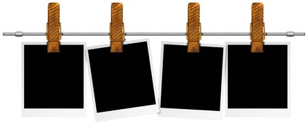 Four blank photos hanging on a steel pole with large clothespin の写真素材