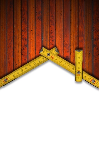 Wood Background and wooden yellow meter tool forming a house on white backgroundの写真素材