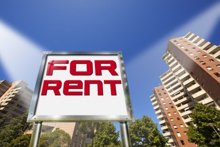 Large chrome billboard with written "for rent" - Tall buildings in the backgroundの写真素材