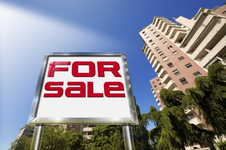 Large chrome billboard with written "for sale" - Tall buildings in the backgroundの写真素材