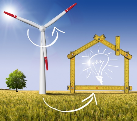 Wooden yellow meter tool forming a ecologic house with wind energy turbine power stationの写真素材