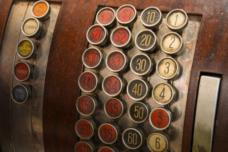 A detail of a vintage dirty cash register with currency in dollarsの写真素材