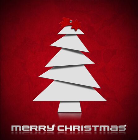White stylized Christmas tree and red comet on red velvet with rose flowerの写真素材