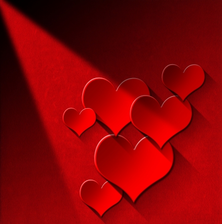 Many stylized red hearts on red velvet background with shadowsの写真素材