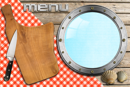 Wooden cutting board, empty metal porthole and kitchen knife, template for recipes or seafood menuの写真素材