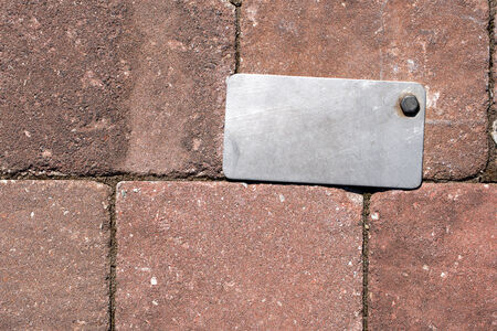 Gray metal label with bolt on a old brown wallの写真素材