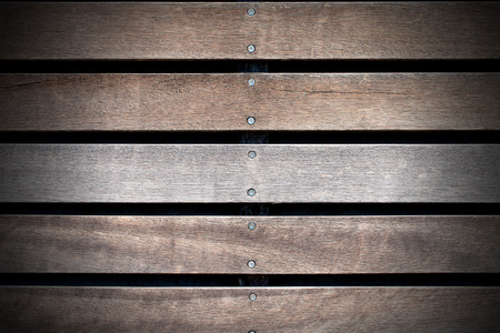 Wooden background with five brown and white boards and screws on black backgroundの写真素材