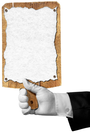 Hand of waiter with white glove holding a old wooden cutting board with empty sheet of paperの写真素材