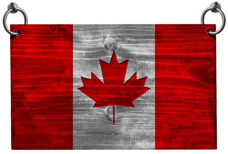 Wooden Canadian flag hanging on to two steel ring isolated on white background with clipping pathの写真素材