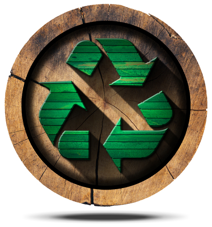 Green wooden recycling symbol on a section of tree trunk isolated on white background.の写真素材