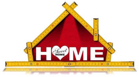 Wooden ruler in the shape of house with text Home sweet home, isolated on white backgroundの写真素材