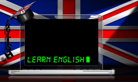 Laptop computer with text Learn English and graduation hat on a desk. Wall with a Uk flagの写真素材