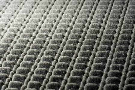 Grey and black abstract background in foam rubberの写真素材