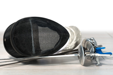 Fencing foil equipment. Three fencing foils with pistol grip (sporting weapon), and a fencing mask...