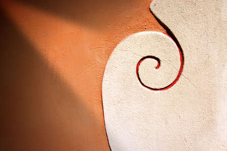 Detail of an orange and white vintage wall with decorationの写真素材