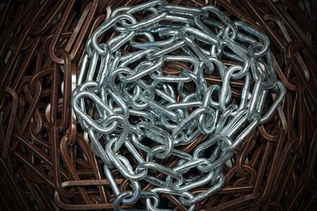 Group of brown and grey metallic chains with dark shadowsの写真素材