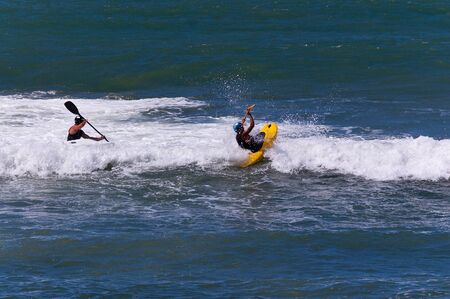 Two kayakers surfing in the white waves of the mediterranean sea, Lerici, La Spezia, Liguria, Italyの写真素材